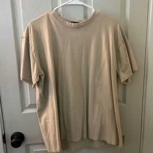 Tan t-shirt from boohoo man with graffiti graphic on back side. Size Medium.